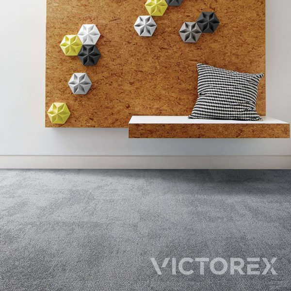 Interface Composure carpet tile in Isolation colour with cork board on wall.