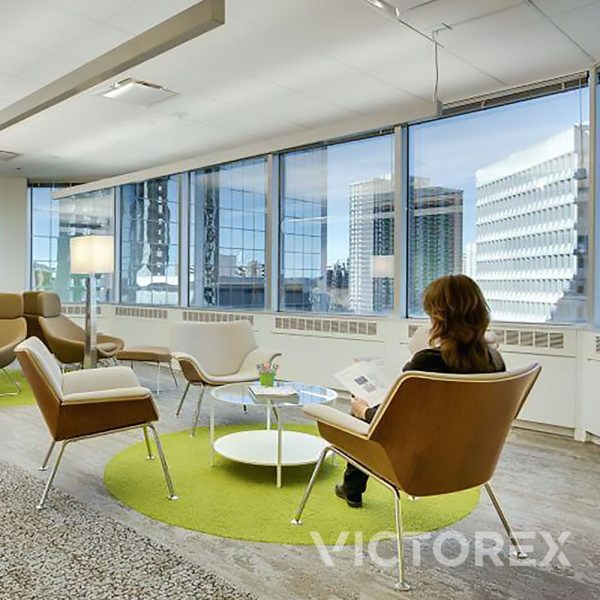 Interface Human Nature HN830 in open workspace with wood shingle wall overlooking multiple office buildings in Kiwi; HN840, Nickel; HN810, Nickel colour