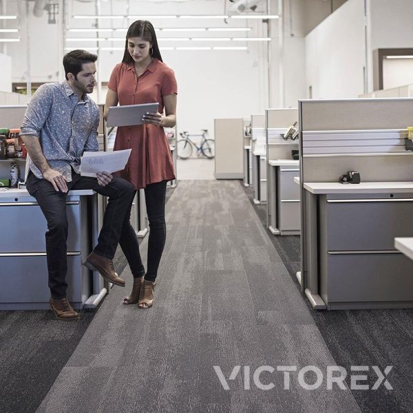 Interface Works Eon carpet tiles in Cinder and Raven colour, two people discussion in office; Ashlar layout.
