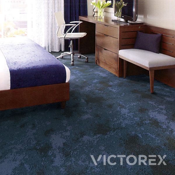 Victorex Geoscape broadloom carpet in Sea Waves colour in a bedroom with vase on the office desk