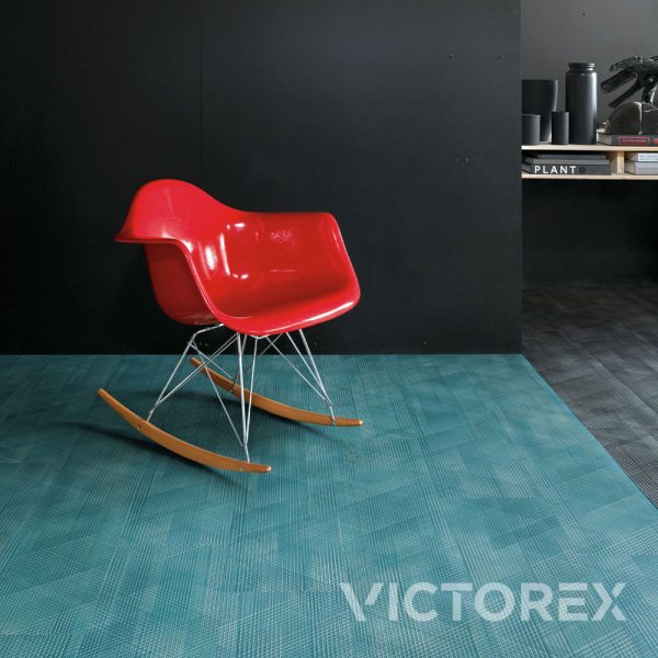 Interface Drawn Lines LVT in Aquamarine colour with a red rocking chair in the middle of a shooting studio