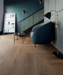 Victorex Resilient Flooring LVT with soft Emerald single sofa in living room with standing reading lamp